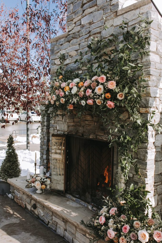 wedding florals on an outdoor fireplace