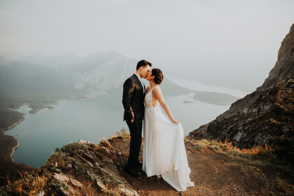 couple kissing on a cliffside during their kananaskis elopement